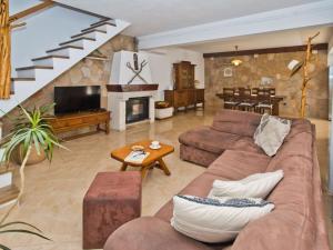 a living room with a couch and a fireplace at Villa in Bogomolje with swimming pool in Bogomolje