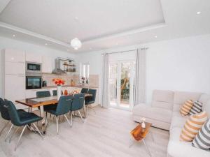 een witte woonkamer met een tafel en een bank bij Matia I with pool in Novak