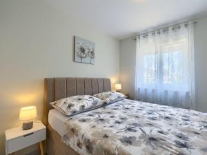 a bedroom with a bed and a window at Apartment Excellence in Pula