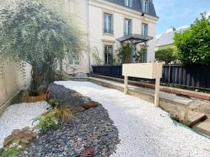 a garden with a sign in front of a building at Amazing holiday home in the Heart of Vittel in Vittel +19 photos