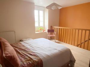 a bedroom with a bed and a window and a chair at Amazing holiday home in the Heart of Vittel in Vittel