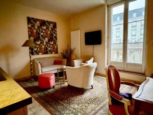 a living room with white furniture and a window at Amazing holiday home in the Heart of Vittel in Vittel