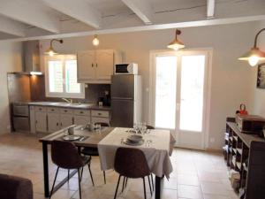 a kitchen with a table with chairs and a refrigerator at Authentic Holiday Home with Charm in Marcoux