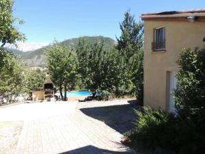 a house and a swimming pool next to a building at Authentic Holiday Home with Charm in Marcoux