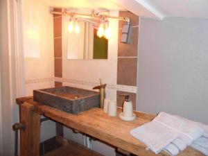 a bathroom with a stone sink and a mirror at Authentic Holiday Home with Charm in Marcoux
