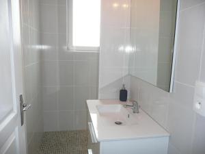 a white bathroom with a sink and a mirror at Apartment in Lilia near Kastell Ac"h Strand in Lilia +26 photos