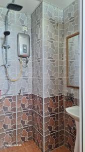 a bathroom with a shower and a sink at ARIAN GOLDSAND SEAVIEW APARMENT glory beach resort in Port Dickson +13 photos