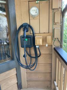 a hose is hooked up to the back of a trailer at Cozy 3BR Dog-Friendly Cabin- Level 2 EV Chgr in Lake Arrowhead