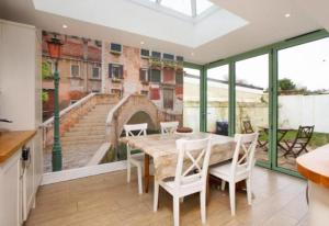 ein Esszimmer mit einem großen Tisch und weißen Stühlen in der Unterkunft 3 bedroom Family home in Budleigh Salterton, Devon in Budleigh Salterton