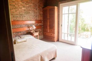 a bedroom with a bed and a large window at Maison Valle in Taquara