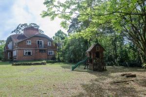 an old house with a playground in front of it at Maison Valle in Taquara +16 photos