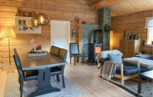 a living room with a dining room table and a fireplace at 3 Bedroom Beautiful Home In Straumgjerde in Brunstad