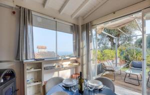 a dining room with a table and chairs and a large window at Casa Persi in Gorleri