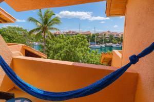 a hammock on a balcony with a view of the water at Ocean & Marina views,Affordable,Spoil yourself! in Puerto Aventuras