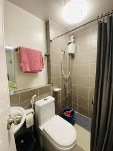 a bathroom with a toilet and a shower at Casa Solana in Butuan +9 photos