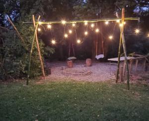 a lit up backyard with a picnic table and lights at Cabaña HobbitXoxo in Xoxocotla