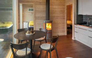 a dining room with a table and a stove at Gorgeous Home In Bolmsö With Lake View in Bolmsö