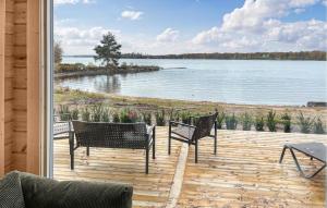a porch with chairs and a view of a lake at Gorgeous Home In Bolmsö With Lake View in Bolmsö