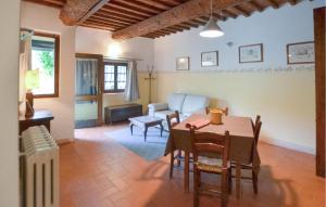 a living room with a table and a couch at Awesome Apartment In Bibbiena in Serravalle