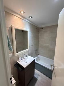 un baño con lavabo y bañera en Las Lomitas Torre London, en Lomas de Zamora