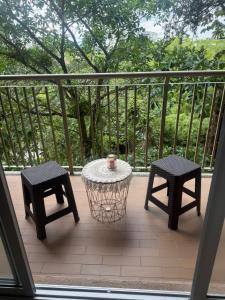 een terras met twee stoelen en een tafel en kruk bij Apartment, 3 bedrooms and 2 full bathrooms in Armenia