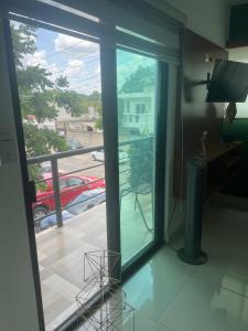 a room with a sliding glass door looking out onto a balcony at Departamento 10 Polanco in Valladolid