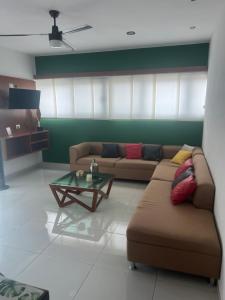 a living room with a couch and a coffee table at Departamento 10 Polanco in Valladolid