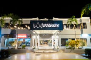 a building with a sign for a pharmacy at night at Hotel Margarita Dynasty in Porlamar