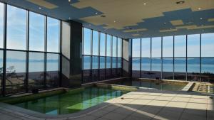 an indoor swimming pool in a building with windows at Goheung Sun Valley Resort in Goheung