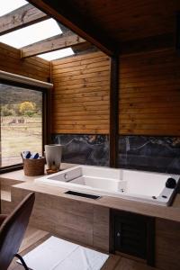 a kitchen with a sink and a large window at Vistas de Mantiqueira in Bom Jardim da Serra