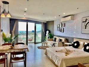 a bedroom with a bed and a living room at The Sóng Apartment Vũng Tàu - Nhà Chill in Vung Tau