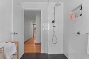 a bathroom with a shower with a glass door at Bonnie Belle, Norwood in Kings Meadows +22 photos