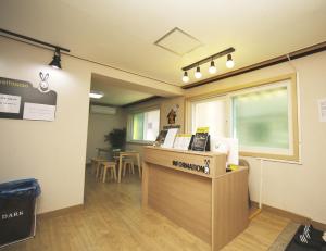 a waiting room with a cash register and a table at 24 Guesthouse KyungHee University in Seoul