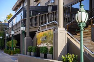 a street light next to a building with a sign that reads exit at Crest on Barkly Hotel in Melbourne