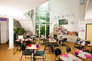 a classroom with tables and chairs in a building at Hotel Cerise Nancy in Nancy