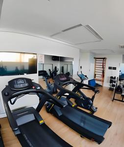 a gym with two treadmills and three exercise bikes at Flat em São Paulo - Completo e Acolhedor in São Paulo