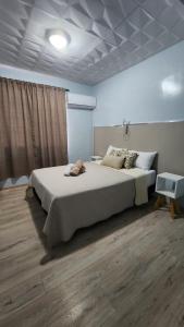 a bedroom with a large bed in a room at Essencial Hotel Spa in Mendoza