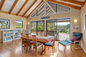 a dining room with a table and chairs at Yallingup Valley Views in Yallingup