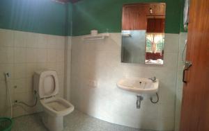 a bathroom with a toilet and a sink at Ever Green Guest House - SHA Plus in Pai