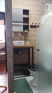 a bathroom with a sink and a counter with a toilet at Suite Bella Vista in Nova Friburgo +7 photos