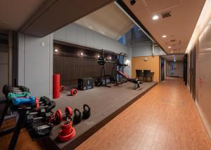 a gym with dumbbells and other equipment in a room at Tabist TOKYO CITY VIEW HOTEL in Tokyo
