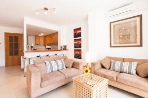 a living room with two couches and a table at Viva Sitges - Sitges Central Apartment in Sitges