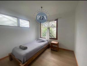 a bedroom with a bed with a pacer sign on it at Casa Lafken in Mirasol +8 photos