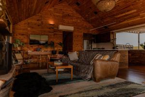 a living room with a couch and a table at Swan River Sanctuary in Swansea