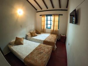 Una cama o camas en una habitación de Hostal casa de los sueños 9 fotos más