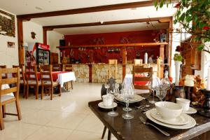 a dining room with a table with plates and wine glasses at Restauracja Rycerska in Iłża +11 photos
