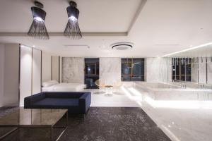 a large bathroom with a tub and a couch at Stayrak Hotel in Seoul