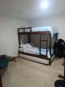 a bedroom with two bunk beds in a room at comfort house san gil in San Gil
