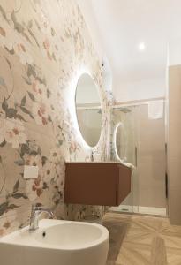 a bathroom with a sink and a mirror at boutique teatro b&b in Foggia