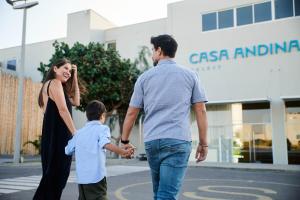 a woman and a man walking with a child at Casa Andina Select Paracas in Paracas
